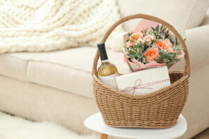 a basket with a bottle of wine and a flower in it